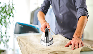 The image shows Polti Vaporella Instant VI50.40 in use on a linen shirt